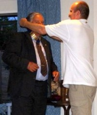 Tim hands over the Presidential Chain to John