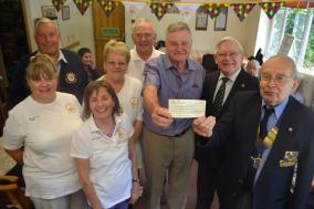 Lions President David Fowler presents the cheque to Warwick Lovegrove from the Day Care Centre