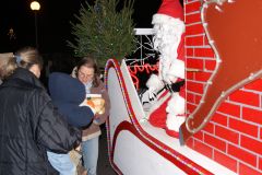 Father Christmas meeting children on one of his tours