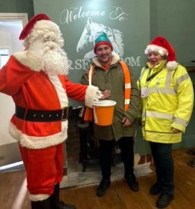 Santa and Lion President Vanessa Donate their takings to the Landlord of the Horse & Groom